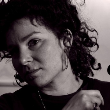 Black and white image with curly hair holding violin
