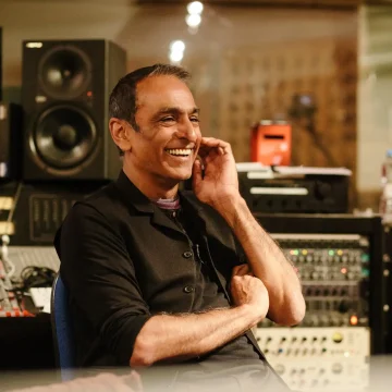 man in recording studio laughing