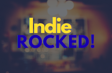 Indie Rocked! yellow and blue text against blurred pub background