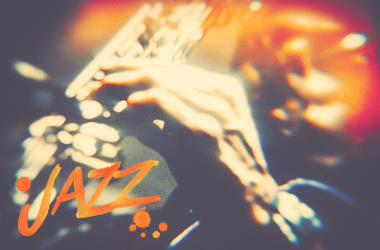 Psychedelic image of man playing saxophone with orange glare. Jazz text in left hand corner