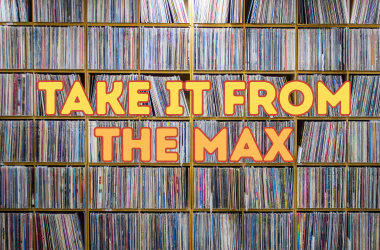 Shelves of vinyl wide shot with bold Take It From the Max text in orange and yellow