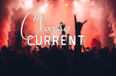 The Classic Current text behind crowd and stage with red tint and smoke