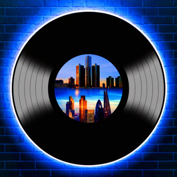 vinyl against neon blue brick wall. London and Detroit skyline illustrations in centre of vinyl